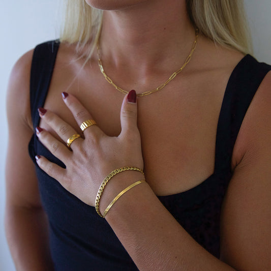 Blonde model wearing gold plated snake chain bracelet