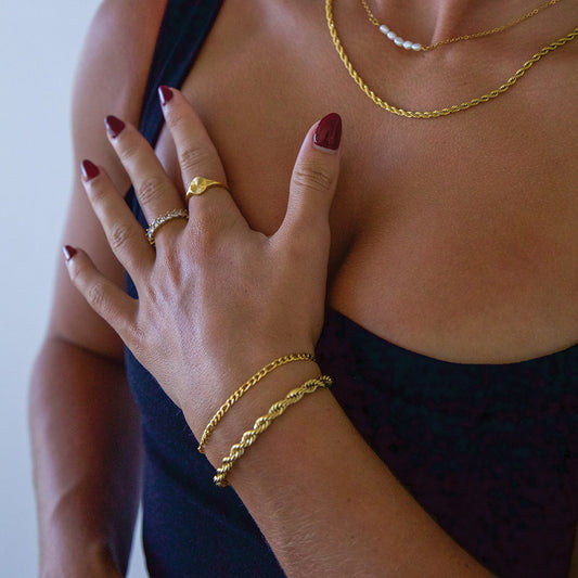 Smaller chain gold plated bracelet on female model